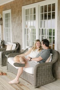 Couple sit on porch at the Wauwinet, Nantucket.