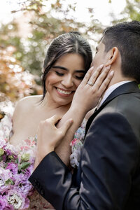 romantic photo of bride caressing partners face