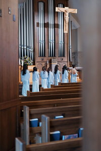 bridesmaids watching catholic ceremony