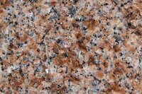 Mountain Rose Granite is a type of natural stone that is known for its pink and gray coloration. The stone typically has a light pinkish-tan background with darker pink and gray veins and speckles throughout. The color variations can range from a light blush pink to a deeper rose color. The stone has a granular texture and is composed of minerals such as quartz, feldspar, and mica.