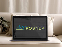 Laptop on a couch displaying "Amy Posner", creative freelancer business coach logo on screen.