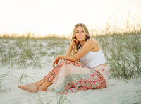 Senior portrait on the beach in Gulf Shores, Alabama — sitting in the sand.