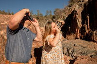 Couple taking a Polaroid photo of each other on the rocks at Water Wheel Falls in Payson