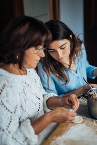 Mother and daughter cooking to improve the menopause