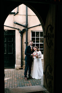 Natural wedding photography at weymouth church, couple hugging in doorway