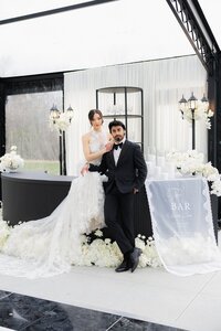 Couple sitting on top of a luxury wedding bar in a high end event space in new england