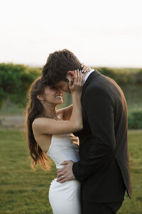 Emotional close-up of bride and groom sharing a quiet embrace at their Tri-Cities vineyard wedding.