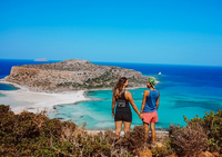 Travelers enjoying a breathtaking coastal view from a scenic hiking trail, perfect for adventure lovers.