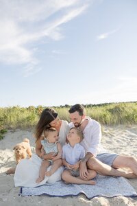 A coastal New England family session with toes in the sand and salty snuggles by the water's edge. North Shore Family Photographer. Deborah Zoe Photography.