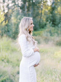 Pregnant mom looking in the distance and smiling