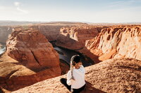 woman sitting on horseshoe bend in arizona