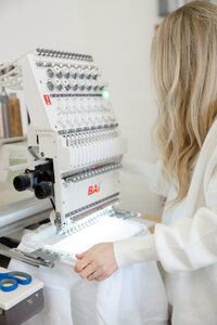 Close-up of embroidery machine producing a custom design. Photograph by Yucaipa branding photographer Kaitlyn Dawn Photography.