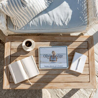 iPad mockup of the Coastal Dream photographer website template displayed on a coastal styled coffee table