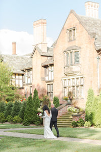 Bride and groom walking on their wedding day at Stan Hywet Hall and Gardens photographed by akron ohio wedding photographer
