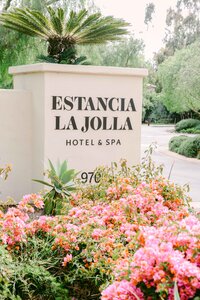 Estancia La Jolla Hotel & Spa entrance sign framed by bougainvillea