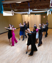 Students dancing with each other learning ballroom dancing during a dance class at Dancers Studio.