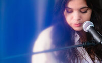 Creative portrait of a singer-songwriter at the piano photographed with blue light effects