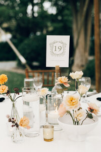 Elegant reception tablescape with white flowers and candles by Flowergirl Cville, Charlottesville wedding florist, at Keswick Vineyard | Photo by Abby Hart Photography