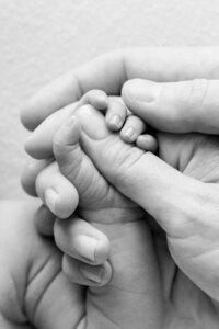 Newborn baby hand wrapped around parent finger Miami newborn photos