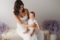 Charleston Mini Sessions - Mother embraces her baby during Mother's Day Mini Session at Holy City Babies in Charleston, SC.