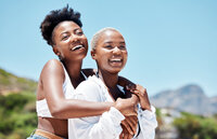 Smiling couple embracing outdoors, capturing joy, love, and travel experiences together.