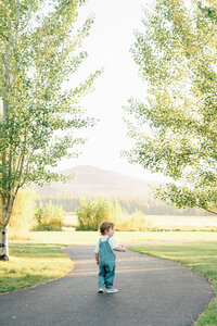 A kid walking during outdoor family session.