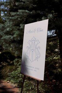 Sign for ceremony with blue monogram.