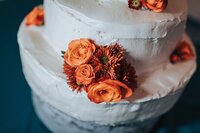 Wedding cake detail with orange flowers