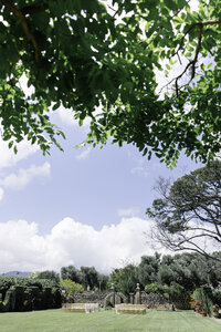 a wedding ceremony set up shown on the lawn of La Pietra in Honolulu