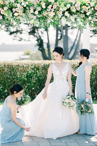 Romantic coastal wedding ceremony in Half Moon Bay, California, featuring a bride and groom with stunning ocean views, sandy beaches, dramatic cliffs, and picturesque sunset skies.