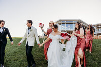 Bride and groom with their bridesmaids and groomsmen in the background