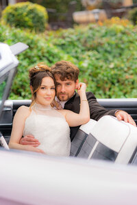 fashion bride and groom sitting in classic car in santa cruz at hollins house