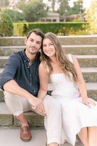 Couple sitting on steps of Eolia Mansion-at Harkness Engagement