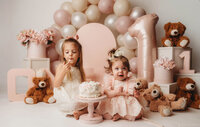 Charleston Cake Smash Photographer- Baby looks into the camera during Cake Smash Photos at Holy City Babies Portrait Studio in Charleston, SC.