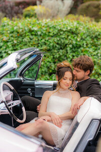 bride and groom sitting in classic car in santa cruz at hollins house
