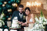 bride and groom cutting cake at table