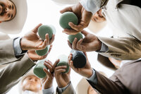 a detailed shot of the groomsmen cheersing while shelly voss captures the moment