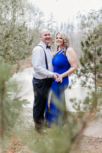 A married couple poses above the water near Lake Superior.