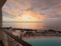 Oceanfront view at AVA Cancun in Mexico, with a glimpse of the lagoon pool and lounge chairs