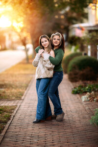 Mother hugging her daughter from behind during a New Bern family portrait session