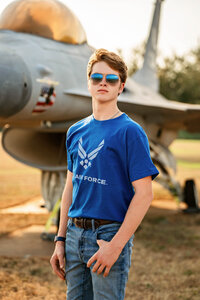 Senior portrait at Battleship Memorial Park in Mobile, Alabama— headshot wearing aviator sunglasses wearing an AirForce t-shirt.