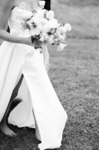 The bride walks holding her flowers
