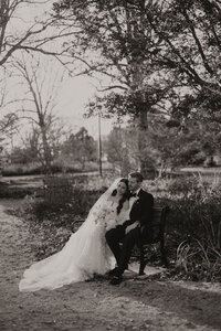 black and white image of bride and groom on ground at Melrose Knitting Mill wedding venue
