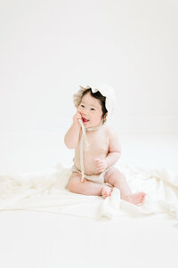 Baby girl sitting on floor in studio