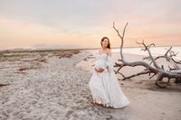 Pregnant woman poses for Maternity Portraits on Folly Beach near Charleston, SC.