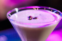 Three espresso beans in the foam of an espresso martini