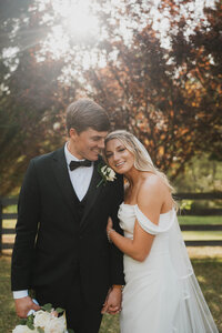 couple hugging each other during outdoor fall wedding day in atlanta, ga