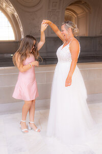 bride twirling little girl at san francisco city hall