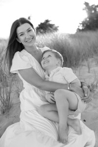 A coastal New England family session with toes in the sand and salty snuggles by the water's edge. North Shore Family Photographer. Deborah Zoe Photography.