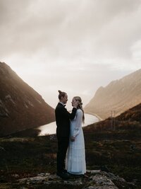 Couple silently enjoying the sunset up on the mountain